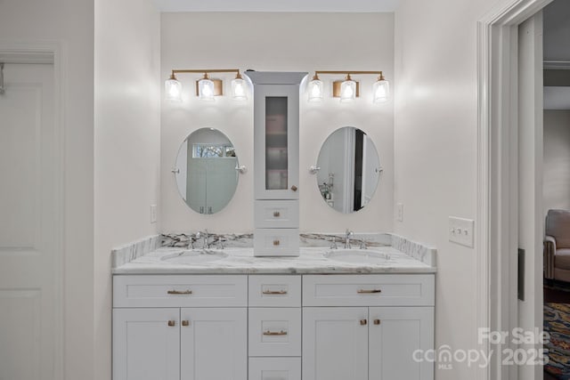 bathroom featuring double vanity, ensuite bath, and a sink