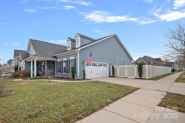 view of side of property featuring a yard, a gate, fence, a garage, and driveway