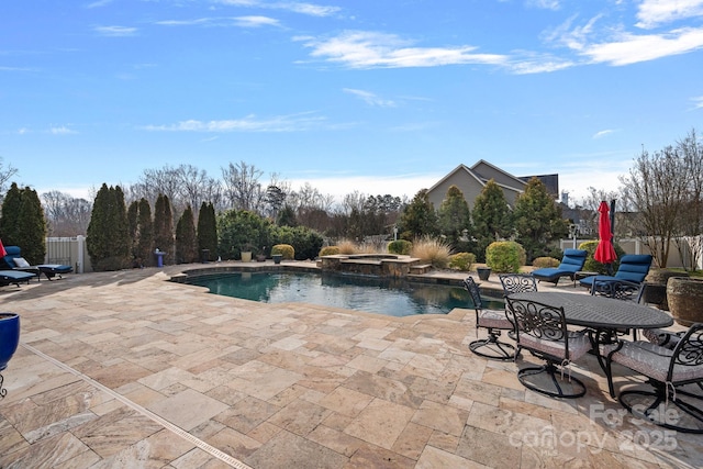 view of swimming pool with a patio area, fence, and a pool with connected hot tub