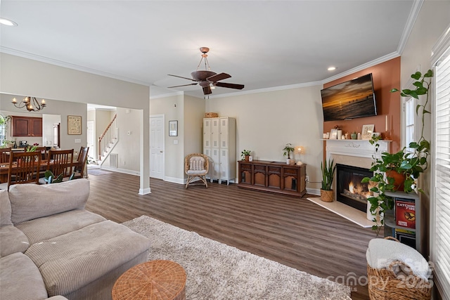 living room with crown molding, a wealth of natural light, and dark hardwood / wood-style flooring