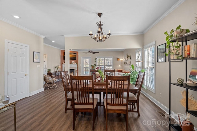 dining room with crown molding, dark hardwood / wood-style floors, and ceiling fan with notable chandelier