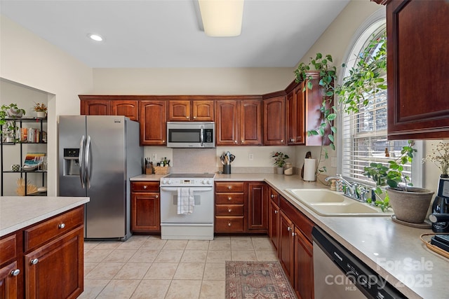 kitchen featuring appliances with stainless steel finishes, sink, and light tile patterned floors