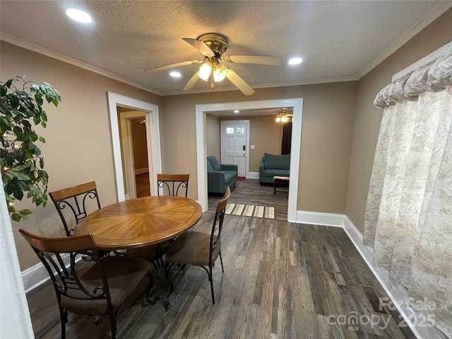 dining area with baseboards, ornamental molding, dark wood-style flooring, a textured ceiling, and recessed lighting