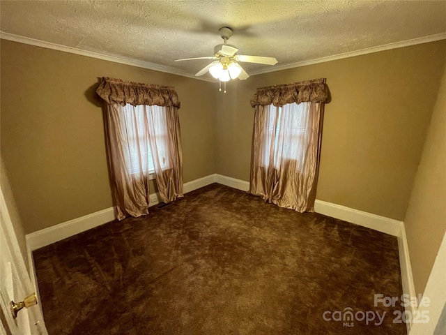 empty room with baseboards, a textured ceiling, dark carpet, and a wealth of natural light