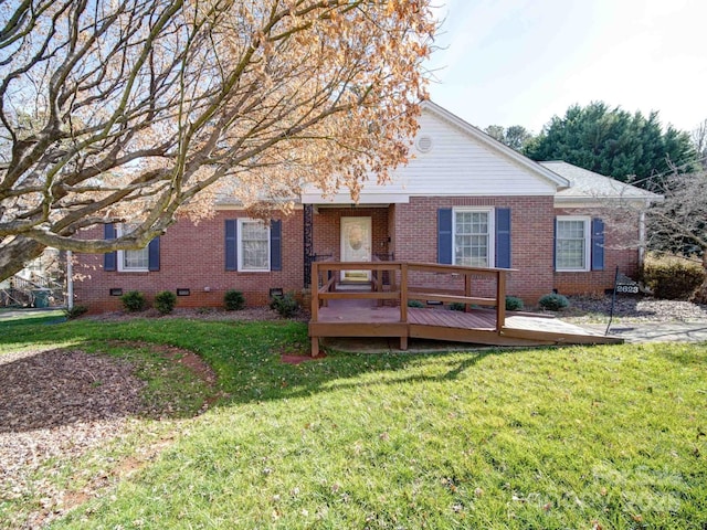 ranch-style house with a deck and a front yard