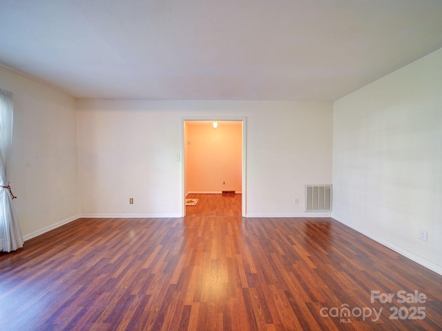 empty room with dark wood-type flooring