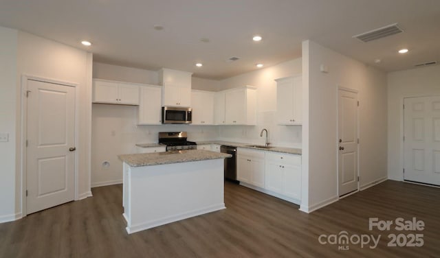 kitchen with white cabinets, visible vents, stainless steel appliances, and a sink