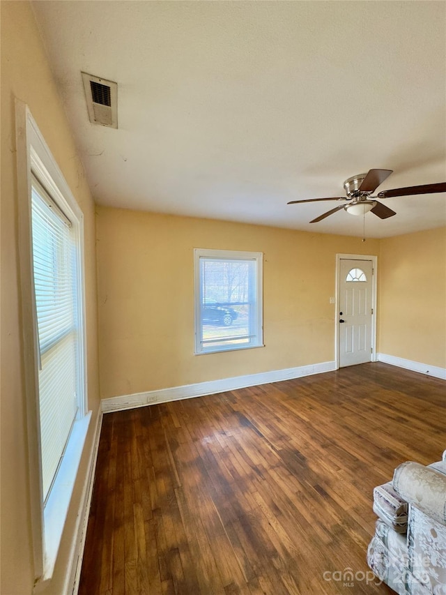 interior space featuring a wealth of natural light, visible vents, and wood finished floors