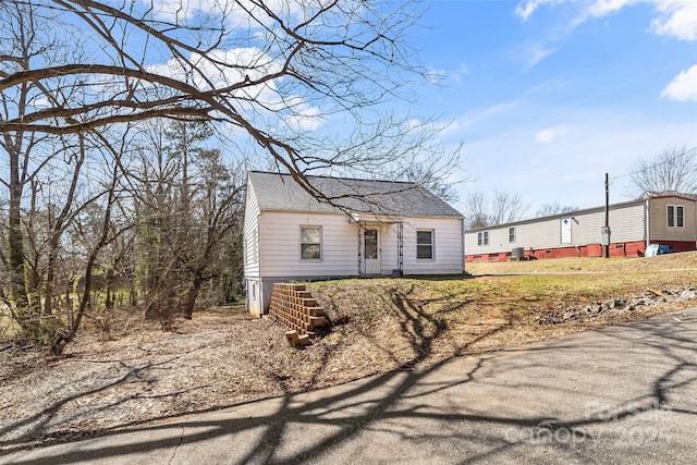 view of front of house featuring roof with shingles