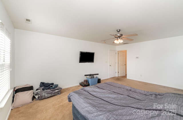 bedroom featuring visible vents, multiple windows, baseboards, and carpet