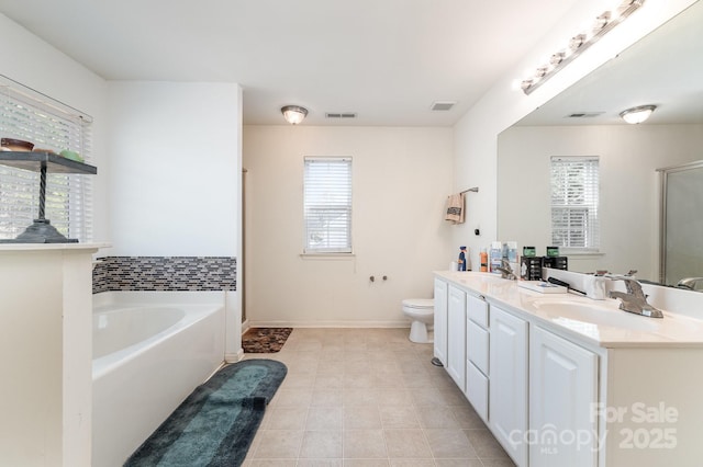 bathroom featuring a sink, visible vents, a garden tub, and a stall shower