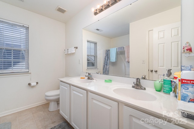 bathroom with tile patterned floors, visible vents, and a sink