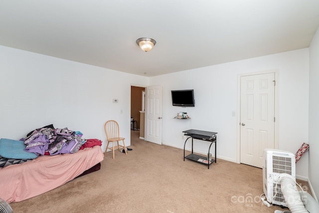 bedroom featuring light carpet and baseboards