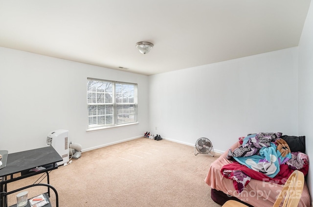 living area featuring baseboards and carpet