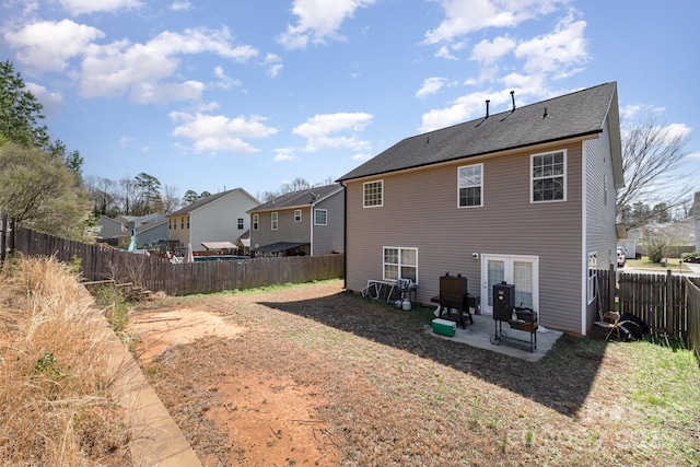 rear view of house with a patio and a fenced backyard