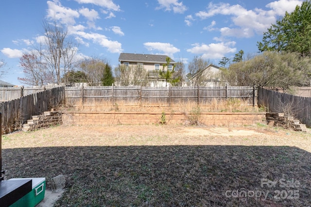 view of yard with a fenced backyard