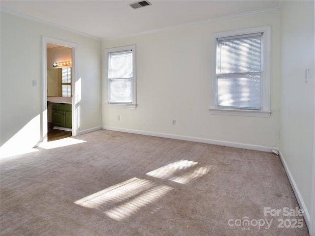 unfurnished bedroom featuring light carpet and crown molding