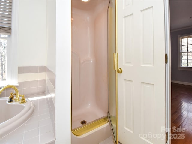 bathroom featuring hardwood / wood-style floors, ornamental molding, and walk in shower