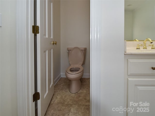 bathroom featuring tile patterned flooring, vanity, and toilet