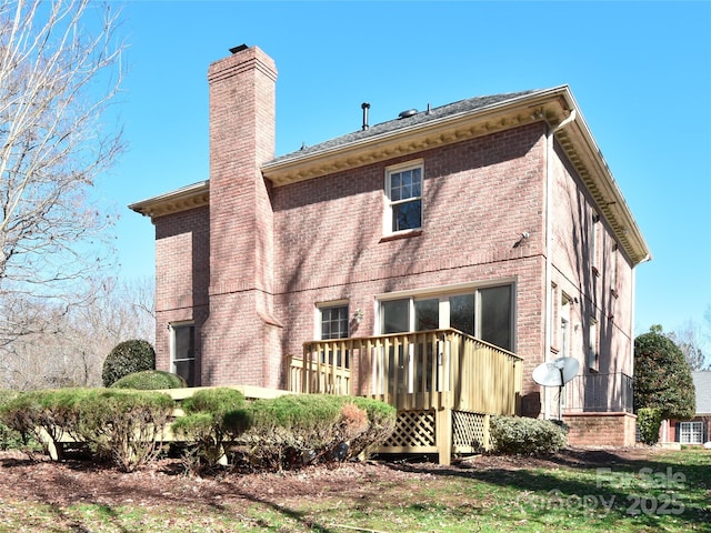 back of house with a deck