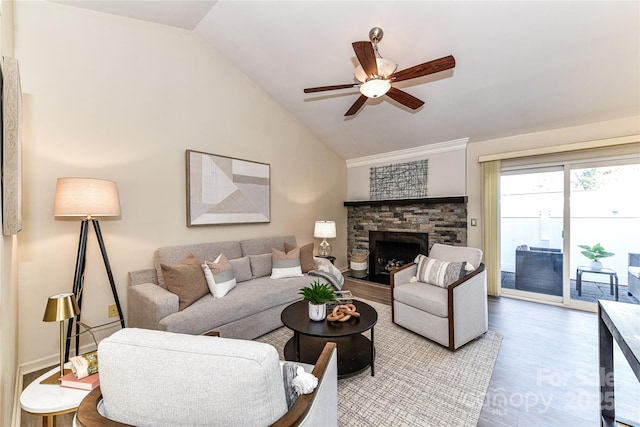 living area with ceiling fan, a fireplace, lofted ceiling, and wood finished floors