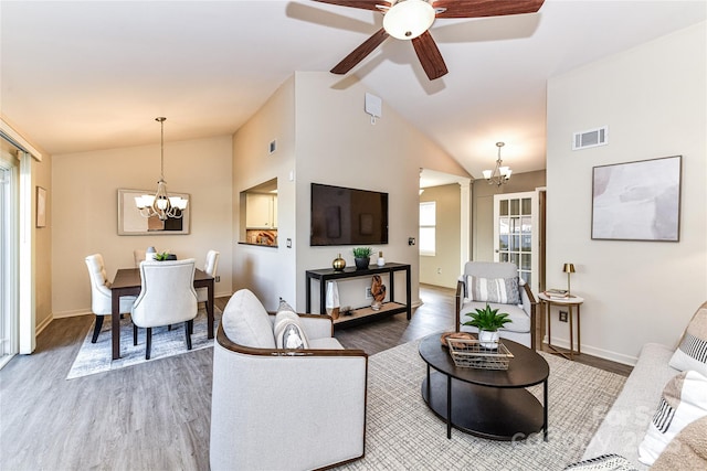 living room with wood finished floors, visible vents, and baseboards