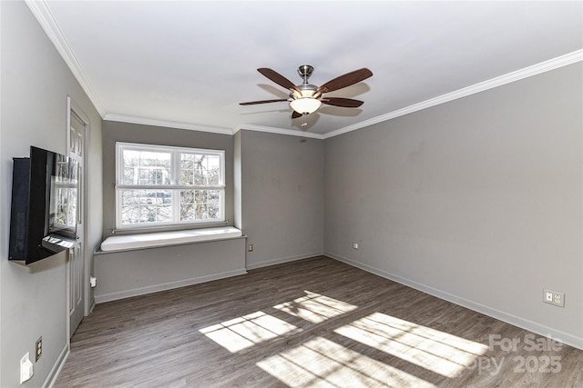 unfurnished room featuring ceiling fan, crown molding, baseboards, and wood finished floors