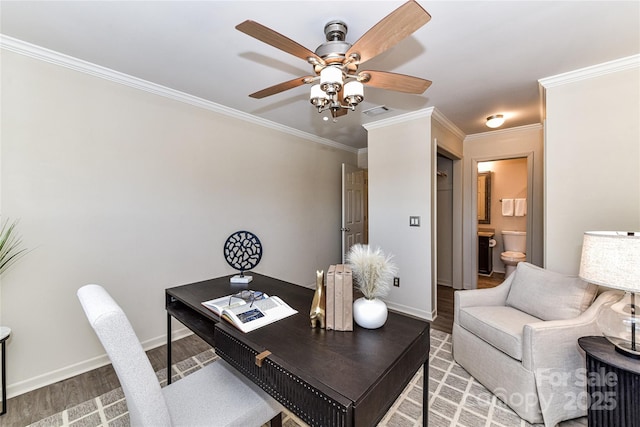 office featuring baseboards, wood finished floors, visible vents, and ornamental molding