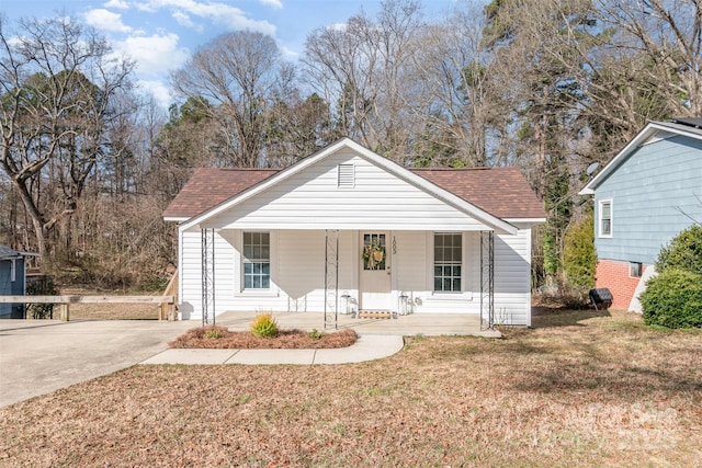 1003 Harris St, Kannapolis, NC 28081 - bungalow-style house featuring covered porch, concrete driveway, a front lawn, and roof with shingles