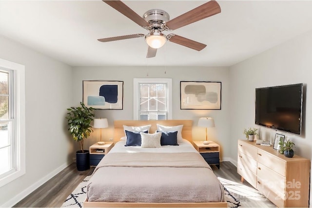 bedroom with a ceiling fan, baseboards, and wood finished floors