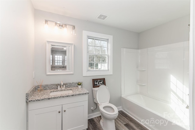 full bathroom featuring visible vents, toilet, vanity, wood finished floors, and baseboards