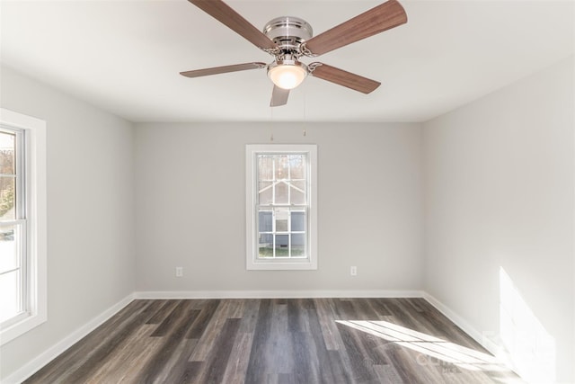 spare room with dark wood finished floors and baseboards