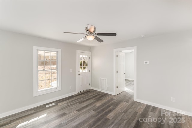 entrance foyer with visible vents, ceiling fan, baseboards, and wood finished floors