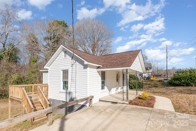 view of home's exterior with a shingled roof