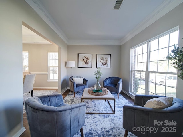 living room with wood-type flooring and ornamental molding