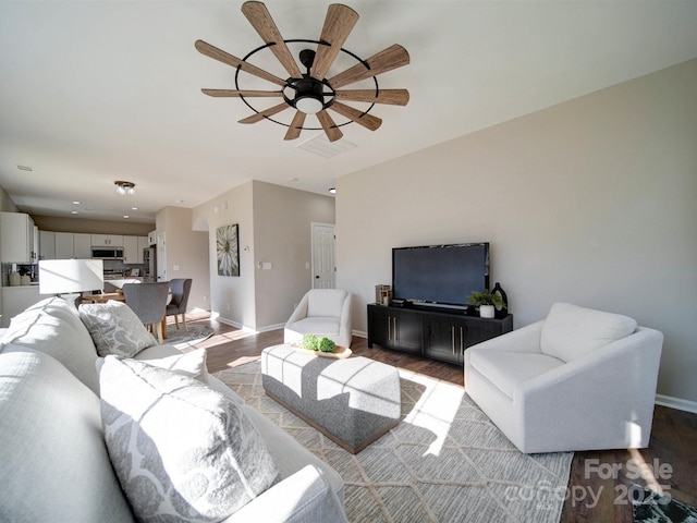 living room featuring ceiling fan and light hardwood / wood-style floors