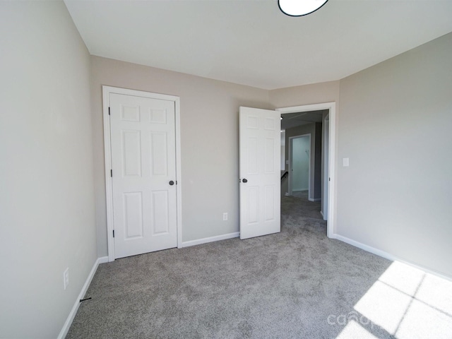 unfurnished bedroom featuring light carpet