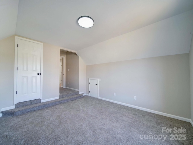 additional living space featuring carpet and lofted ceiling