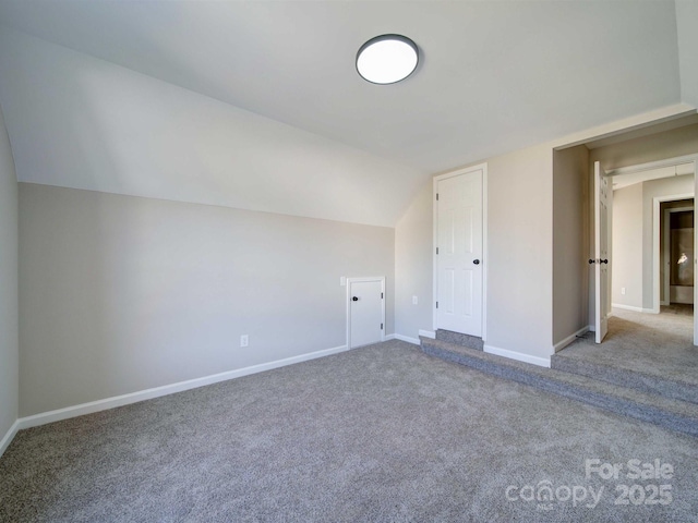 additional living space with carpet floors and lofted ceiling