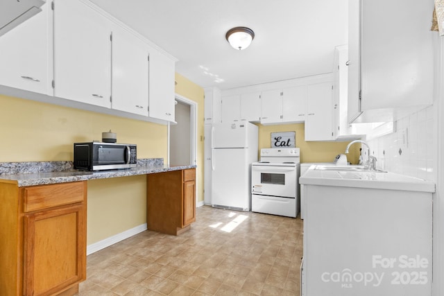 kitchen with white cabinetry, white appliances, and sink