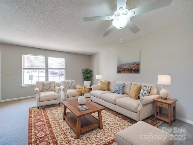 carpeted living room with a ceiling fan, a textured ceiling, and baseboards