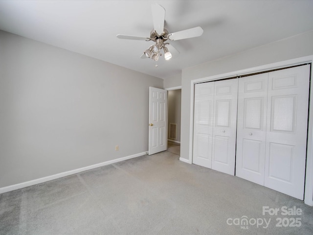 unfurnished bedroom with carpet, visible vents, baseboards, and a closet