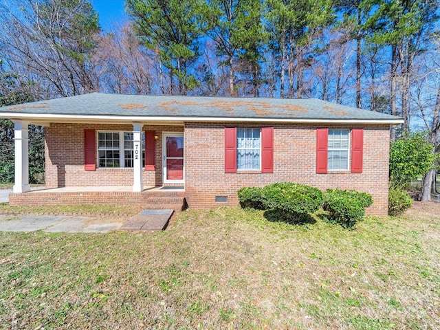 ranch-style house with crawl space, covered porch, a front lawn, and brick siding