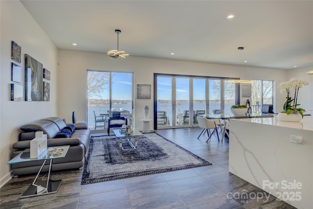 living area with a water view and recessed lighting