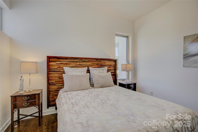 bedroom with dark wood-style floors and baseboards