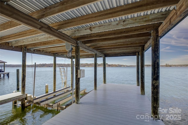 dock area with a water view and boat lift