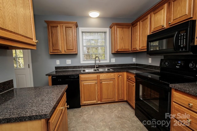 kitchen with a wealth of natural light, sink, dark stone counters, and black appliances