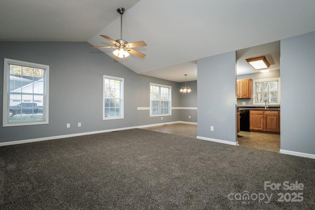 unfurnished living room with dark carpet, sink, vaulted ceiling, and ceiling fan with notable chandelier