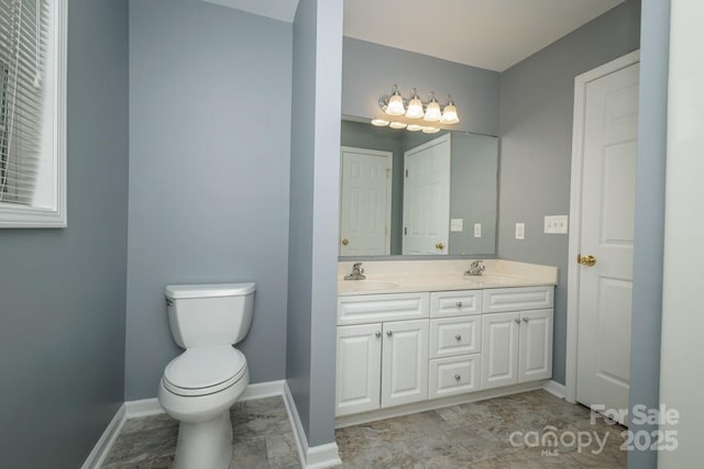 bathroom featuring toilet and vanity