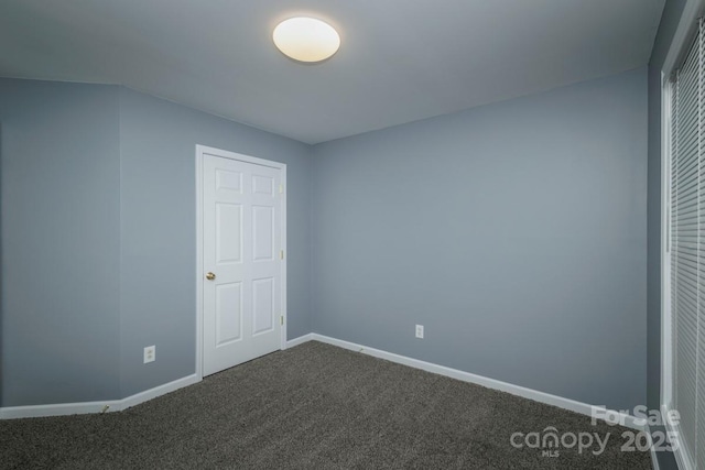 unfurnished bedroom with dark colored carpet